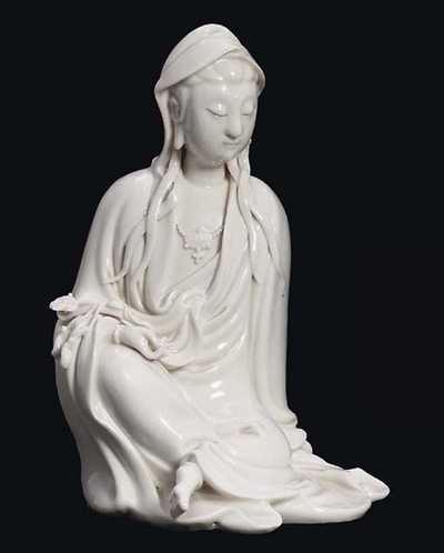 POTTER’S MARK HE CHAOZONG, 19TH CENTURY A BLANC DE CHINE SEATED FIGURE OF GUANYIN